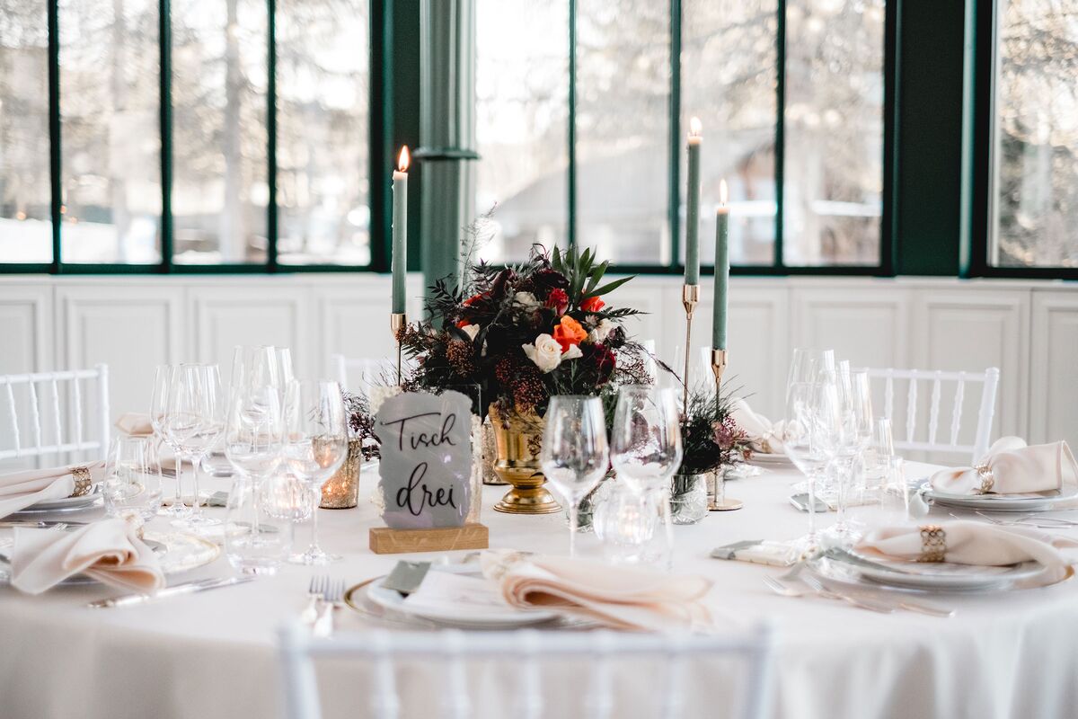 Festive wedding table with candles and bouquet of flowers