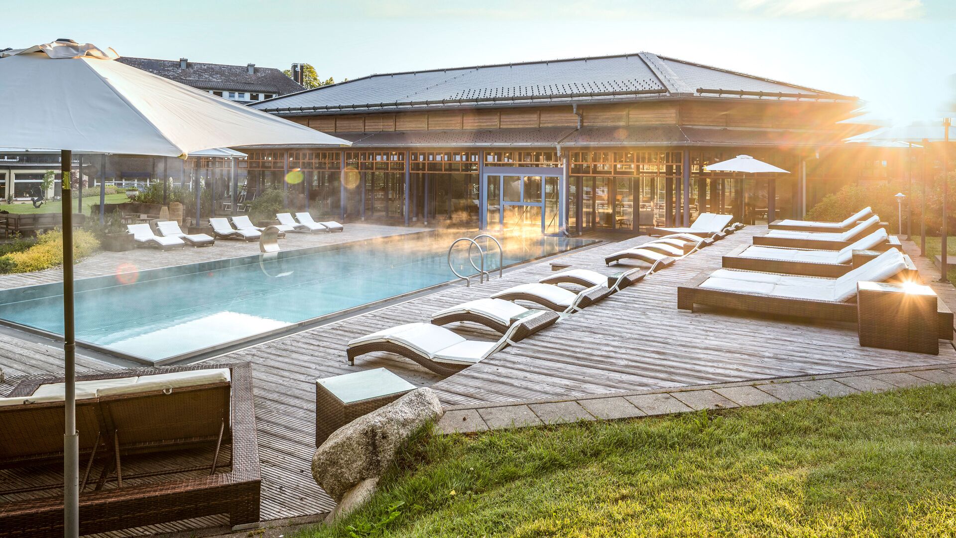 Large swimming pool with sunbathing terrace