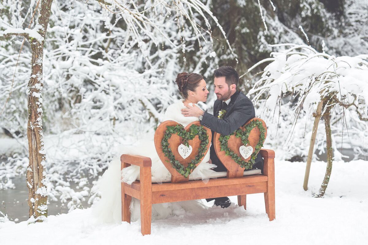 Winter wedding on the bench in the hotel park with couple